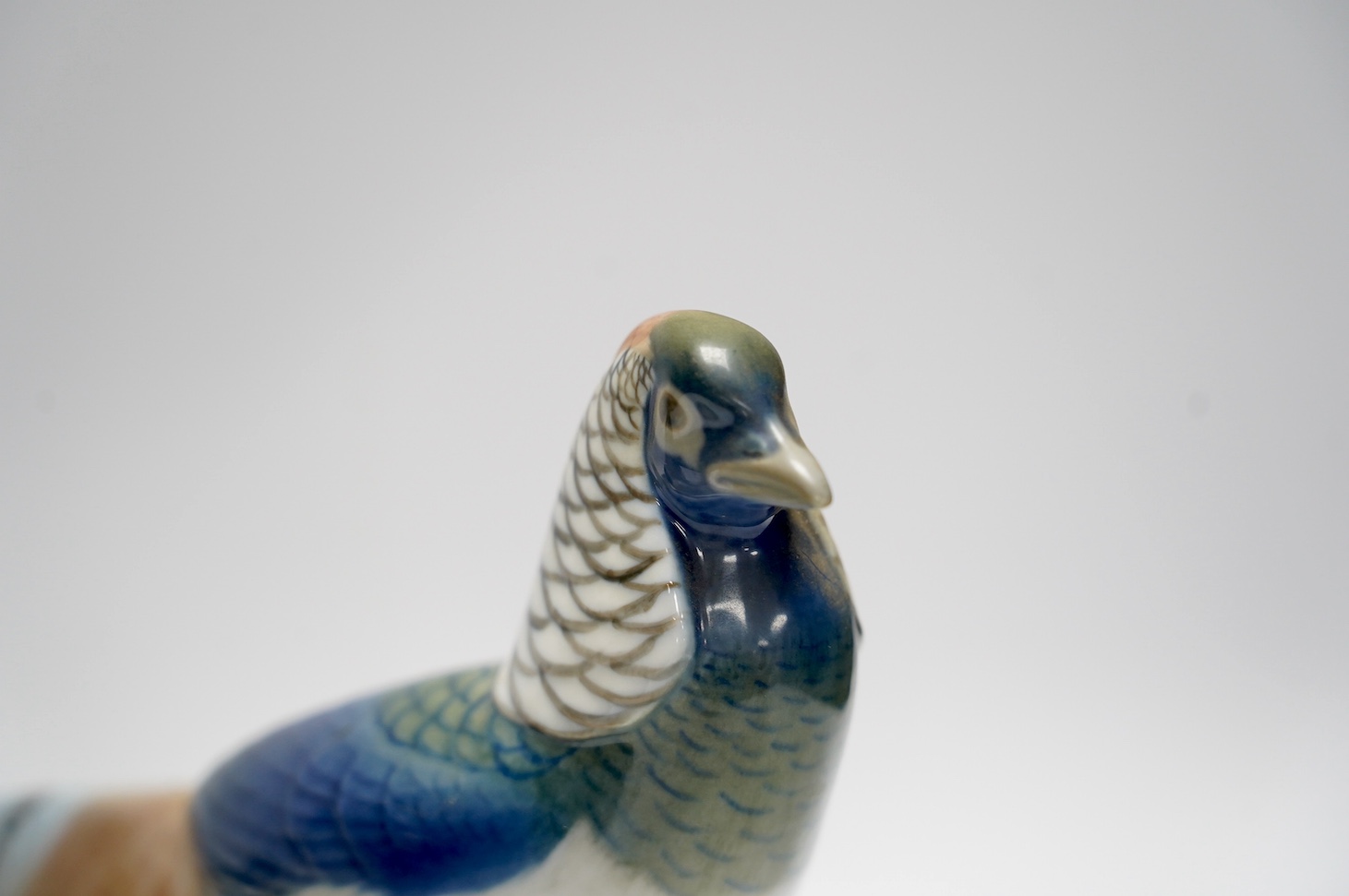 A Royal Copenhagen puppy, 20cm high, and a pheasant. Condition - good